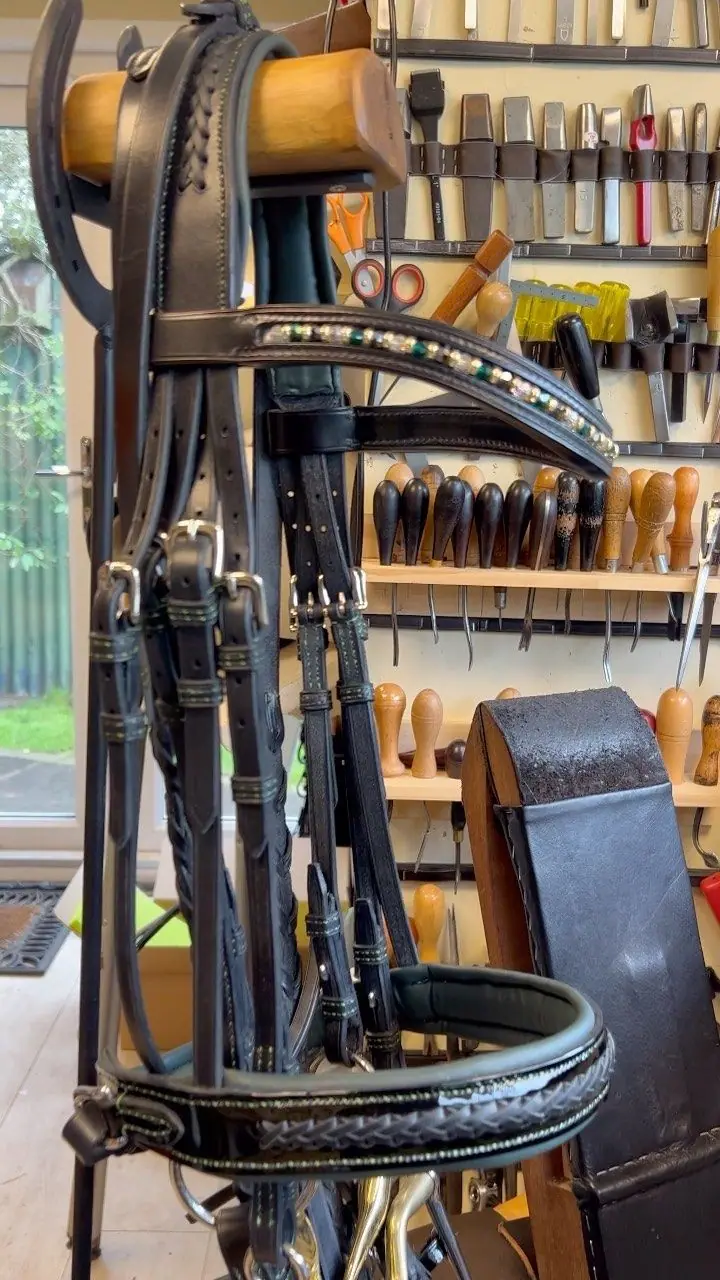 A hand-made double bridle on a stand in the workshop