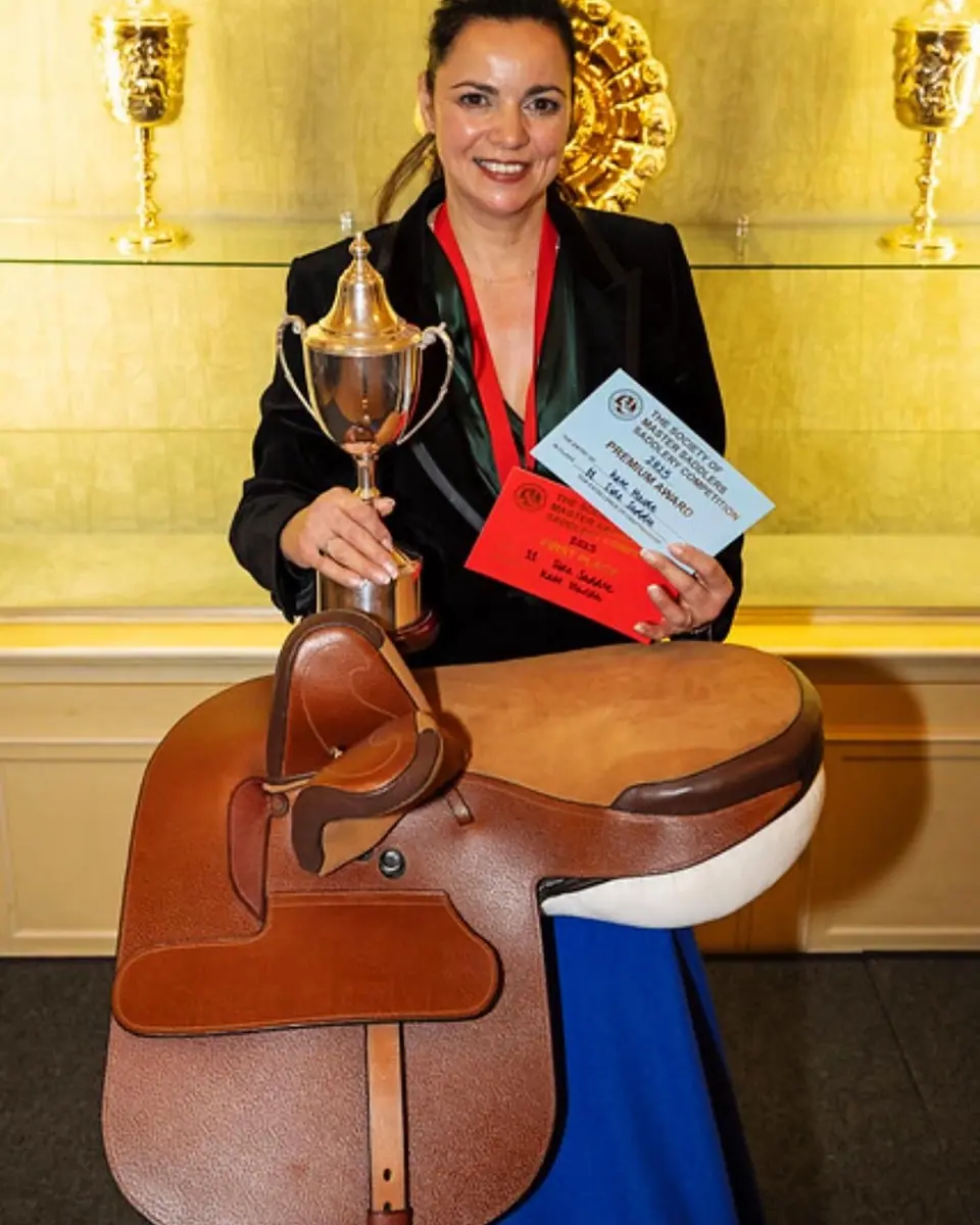 Kate holding the Side Saddle Association Cup beside her winning side saddle