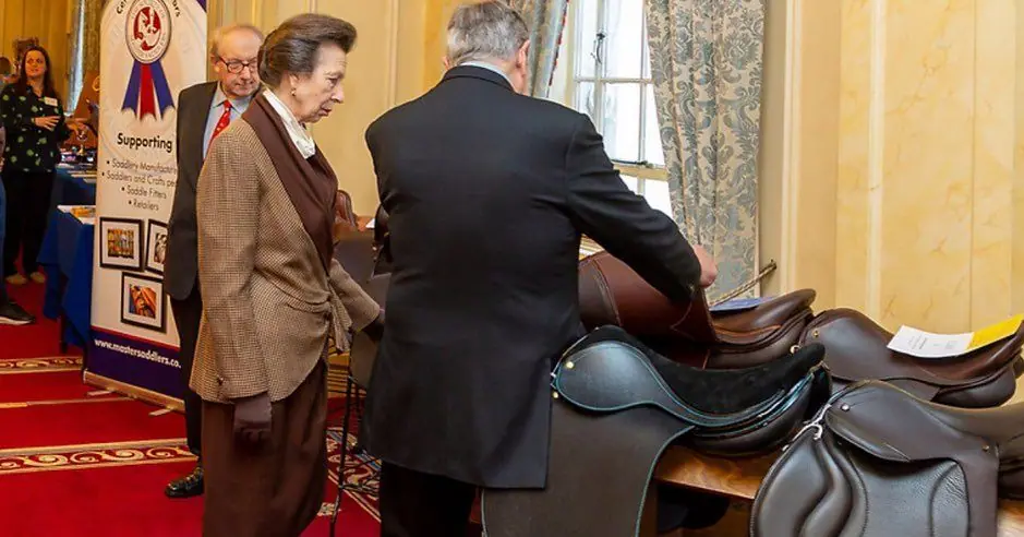 HRH The Princess Royal looking at Kate's saddle at Saddlers' Hall in 2023
