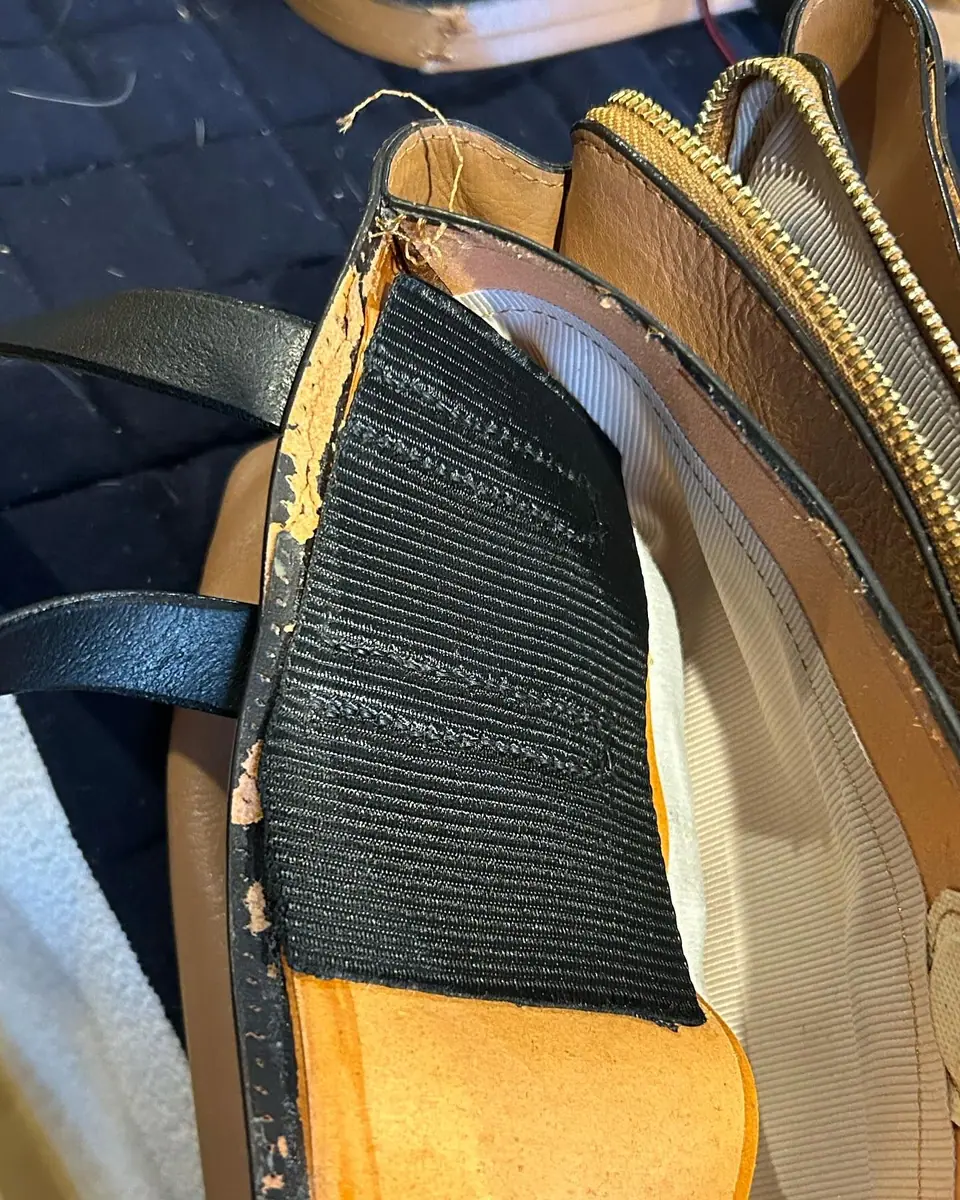The handbag before, with the old strap worn through