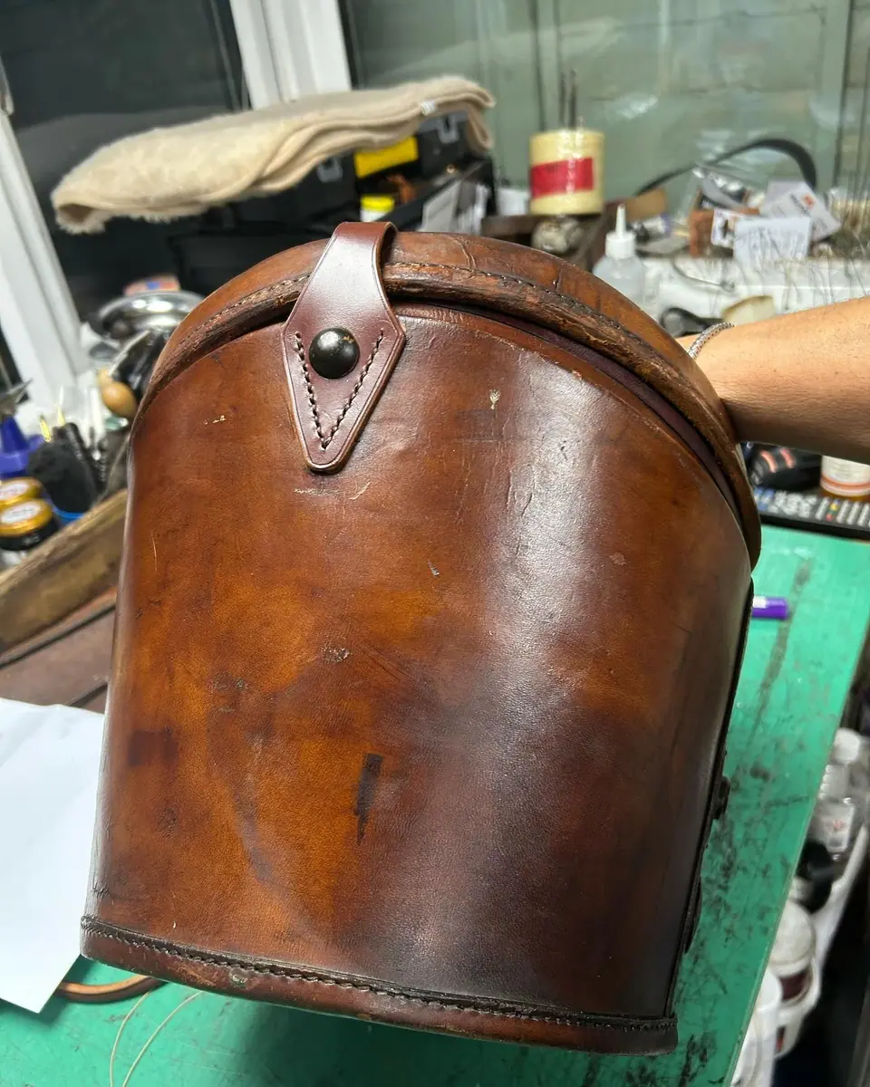 A leather top hat box after cleaning and treatment